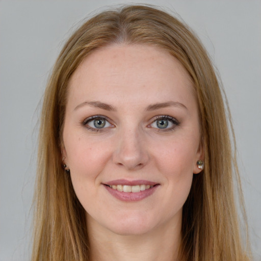 Joyful white young-adult female with long  brown hair and green eyes