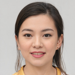 Joyful asian young-adult female with medium  brown hair and brown eyes