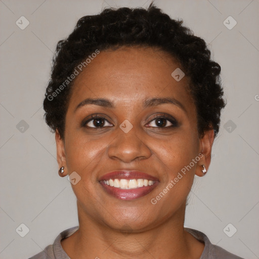 Joyful black young-adult female with short  brown hair and brown eyes