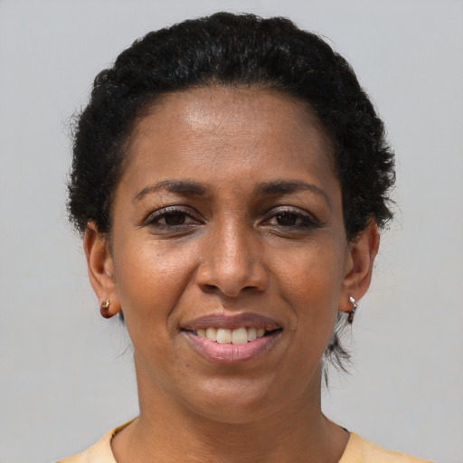 Joyful black adult female with short  brown hair and brown eyes