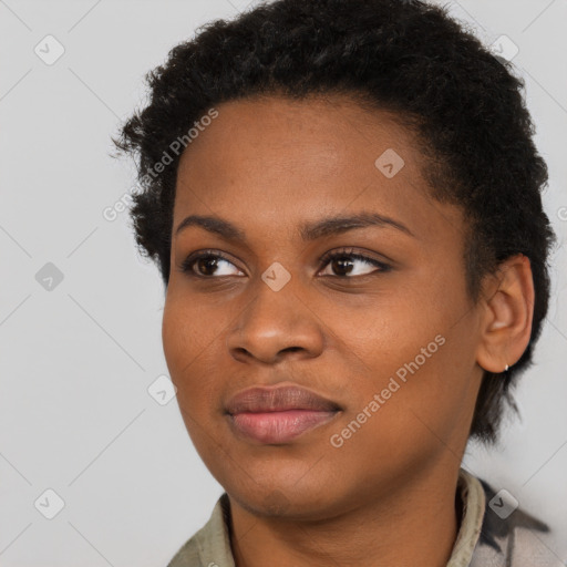 Joyful black young-adult female with short  black hair and brown eyes