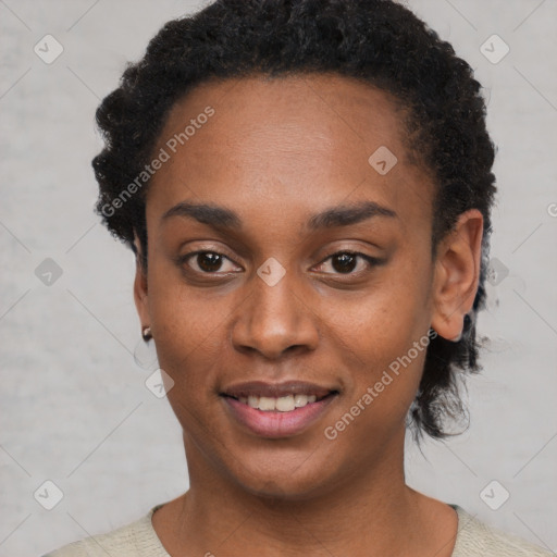 Joyful black young-adult female with short  black hair and brown eyes