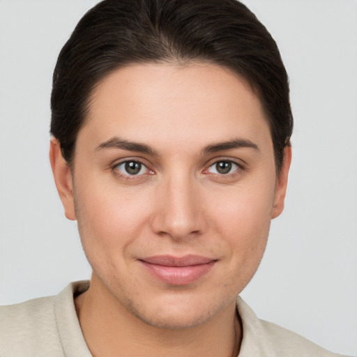 Joyful white young-adult female with short  brown hair and brown eyes