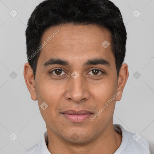 Joyful white young-adult male with short  black hair and brown eyes