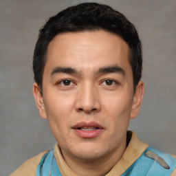 Joyful white young-adult male with short  black hair and brown eyes