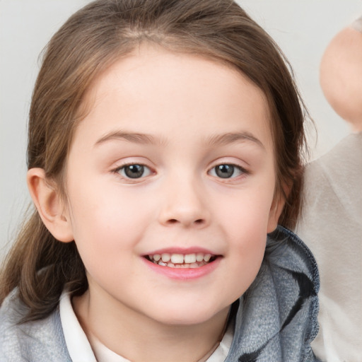 Joyful white child female with medium  brown hair and blue eyes