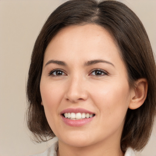 Joyful white young-adult female with medium  brown hair and brown eyes