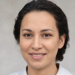 Joyful white adult female with medium  brown hair and brown eyes