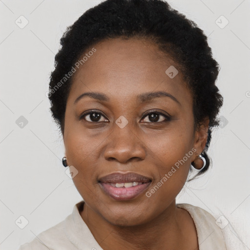 Joyful black adult female with short  black hair and brown eyes