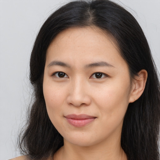Joyful asian young-adult female with long  brown hair and brown eyes