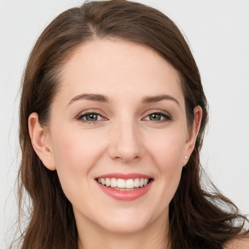 Joyful white young-adult female with long  brown hair and grey eyes