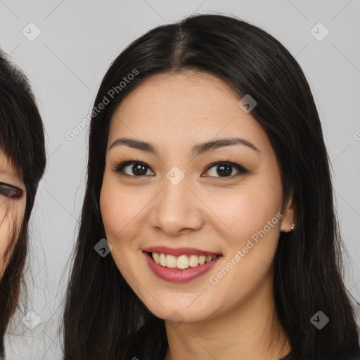 Joyful asian young-adult female with long  brown hair and brown eyes