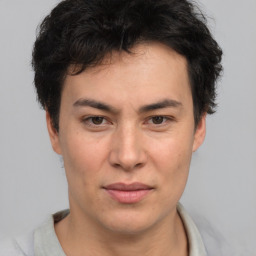 Joyful asian young-adult male with short  brown hair and brown eyes