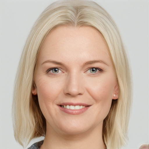 Joyful white young-adult female with long  blond hair and blue eyes