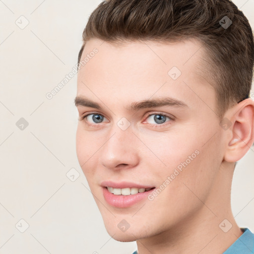 Joyful white young-adult male with short  brown hair and grey eyes