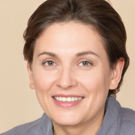 Joyful white adult female with medium  brown hair and brown eyes