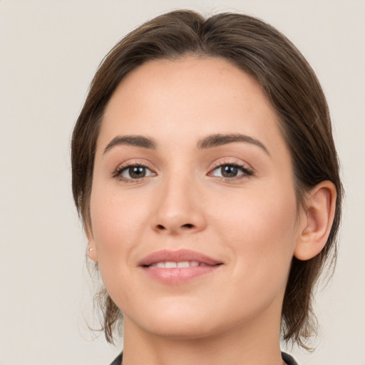 Joyful white young-adult female with medium  brown hair and brown eyes