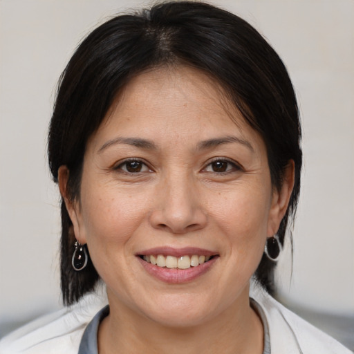 Joyful white adult female with medium  brown hair and brown eyes