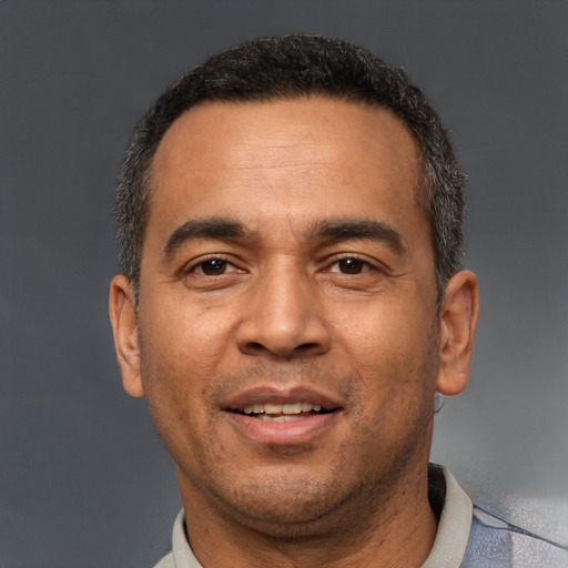 Joyful white adult male with short  black hair and brown eyes