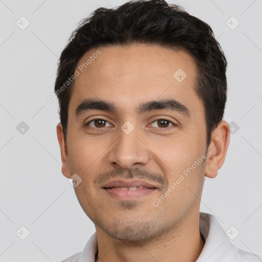 Joyful latino young-adult male with short  black hair and brown eyes