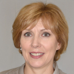 Joyful white adult female with medium  brown hair and blue eyes