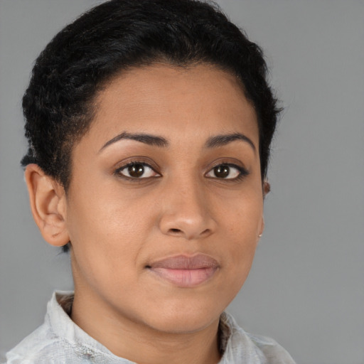 Joyful latino young-adult female with short  brown hair and brown eyes