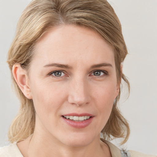 Joyful white young-adult female with medium  brown hair and blue eyes