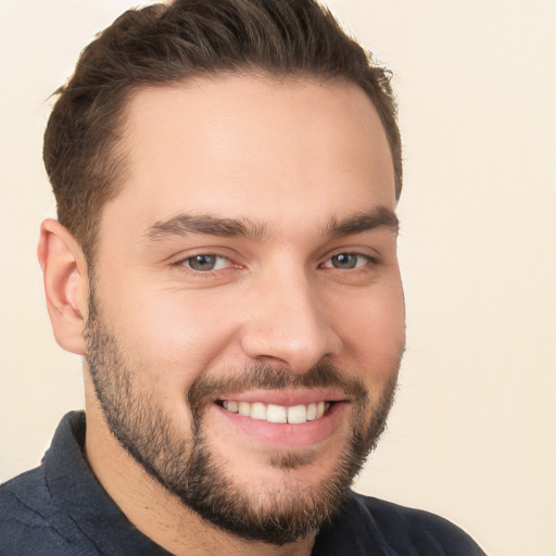 Joyful white young-adult male with short  brown hair and brown eyes