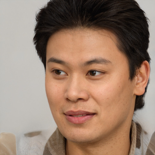 Joyful asian young-adult male with short  brown hair and brown eyes