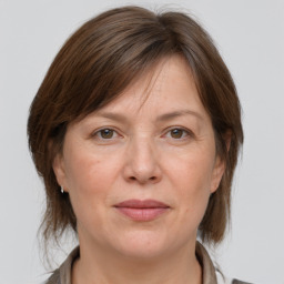 Joyful white adult female with medium  brown hair and grey eyes