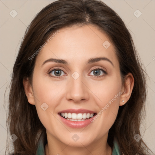 Joyful white young-adult female with long  brown hair and grey eyes