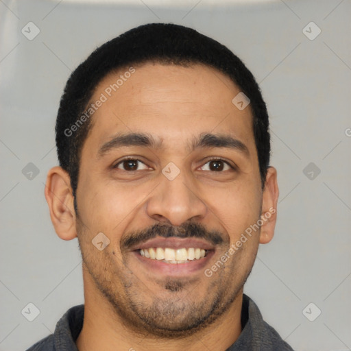 Joyful latino young-adult male with short  black hair and brown eyes