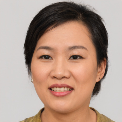 Joyful asian young-adult female with medium  brown hair and brown eyes