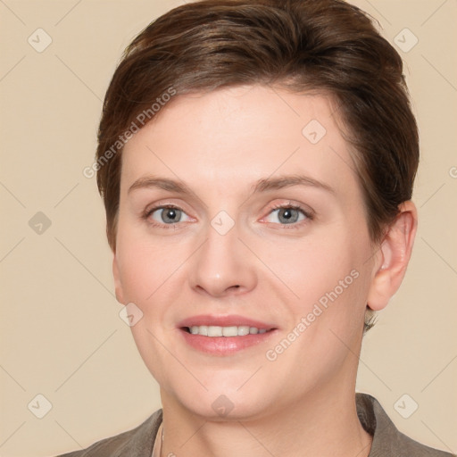 Joyful white young-adult female with short  brown hair and grey eyes