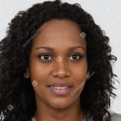 Joyful black young-adult female with long  brown hair and brown eyes