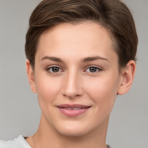 Joyful white young-adult female with short  brown hair and grey eyes