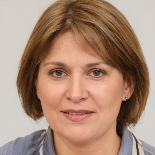 Joyful white adult female with medium  brown hair and brown eyes