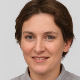 Joyful white adult female with medium  brown hair and grey eyes