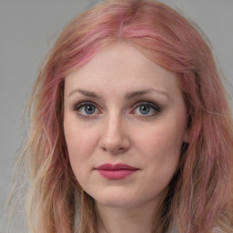 Joyful white young-adult female with long  brown hair and blue eyes