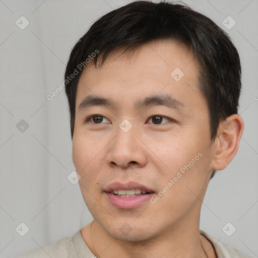 Joyful asian young-adult male with short  brown hair and brown eyes