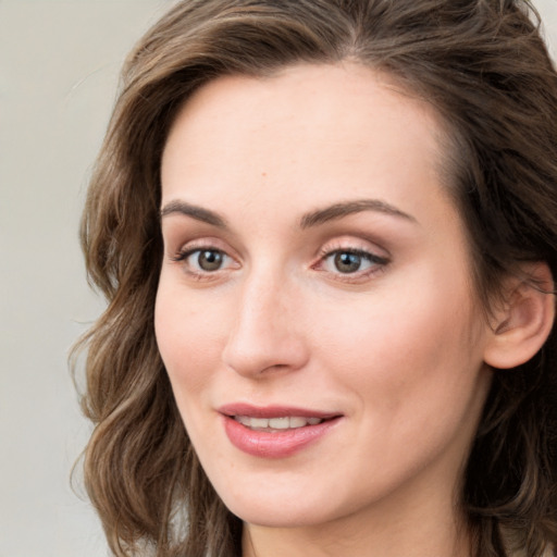 Joyful white young-adult female with long  brown hair and green eyes