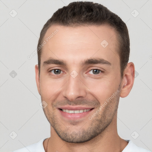 Joyful white young-adult male with short  brown hair and brown eyes