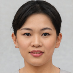 Joyful asian young-adult female with short  brown hair and brown eyes