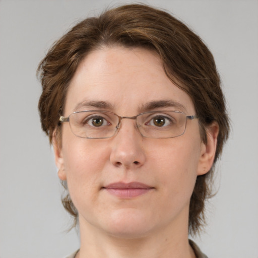 Joyful white adult female with medium  brown hair and green eyes