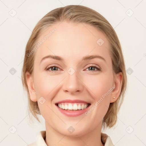 Joyful white young-adult female with medium  brown hair and blue eyes