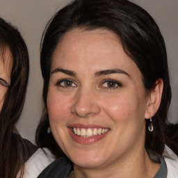 Joyful white adult female with medium  brown hair and brown eyes