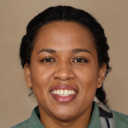 Joyful black adult female with short  brown hair and brown eyes