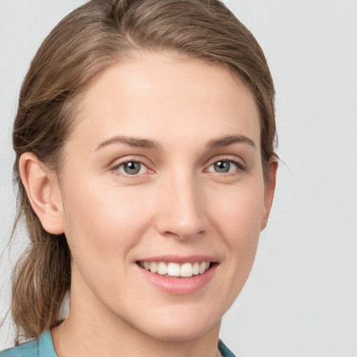 Joyful white young-adult female with medium  brown hair and blue eyes