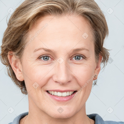 Joyful white adult female with medium  brown hair and blue eyes