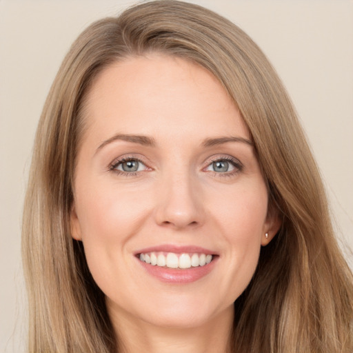 Joyful white young-adult female with long  brown hair and grey eyes